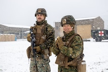 U.S. Navy RP2 Louis Ortiz, left, a religious program specialist, and Lt. Cdr. Saejeong Kim, right, a chaplain, both with Combat Logistics Regiment 3 (CLR-3), 3rd Marine Logistics Group, pose for a photo during exercise Winter Workhorse (WWH) 25 at Warrior Base, South Korea, on March 3, 2025.