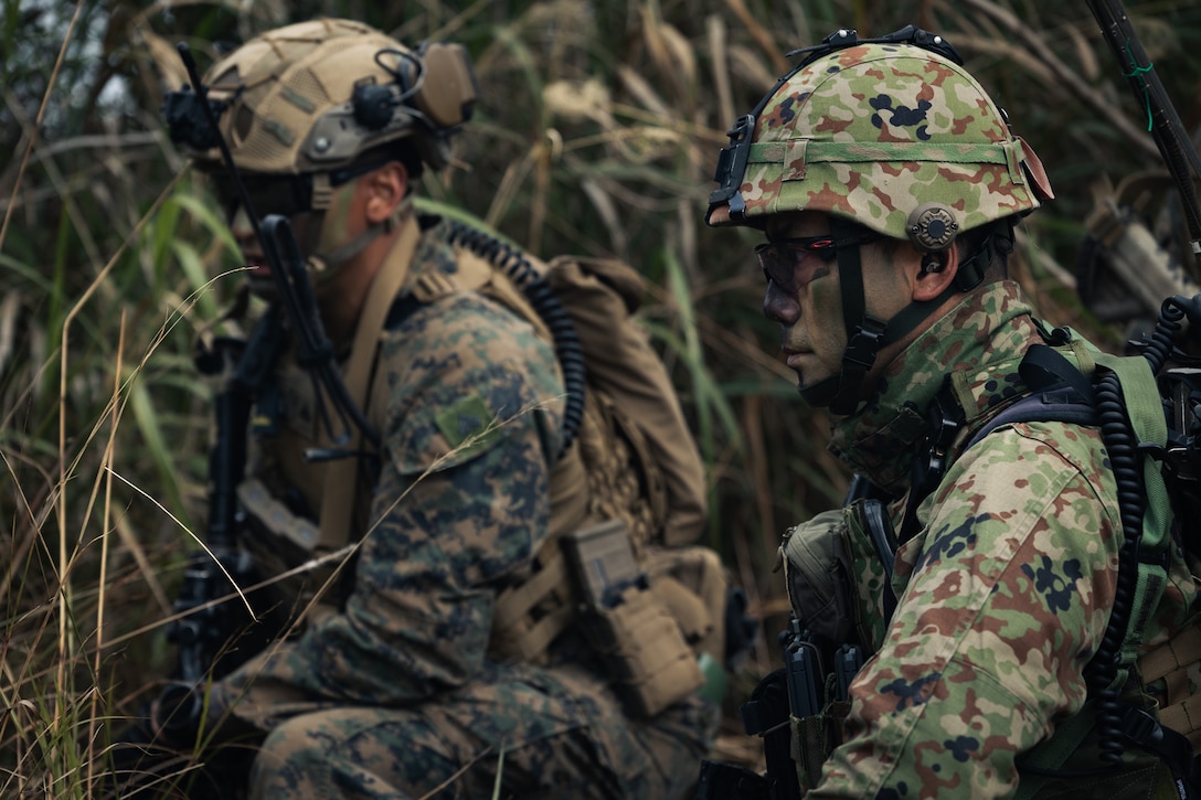 A U.S. Marine, left, with Echo Company, Battalion Landing Team 2/4, 31st Marine Expeditionary Unit, and a Japan Ground Self-Defense Force soldier, right, with the 1st Amphibious Rapid Deployment Regiment, prepare to conduct simulated integrated squad attacks at Camp Hansen, Okinawa, Japan, Feb. 24, 2025. The training was conducted to strengthen cohesion between partner forces and to share tactics, techniques, and procedures during Iron Fist 25. Iron Fist is an annual bilateral exercise designed to increase interoperability and strengthen the relationships between the U.S. Marine Corps, the U.S. Navy, the JGSDF, the Japan Maritime Self-Defense Force, and the Japan Air Self-Defense Force. The 31st MEU, the Marine Corps’ only continuously forward deployed MEU, provides a flexible and lethal force, ready to perform a wide range of military operations as the premiere crisis response force in the Indo-Pacific region. (U.S. Marine Corps photo by Cpl. Alora Finigan)