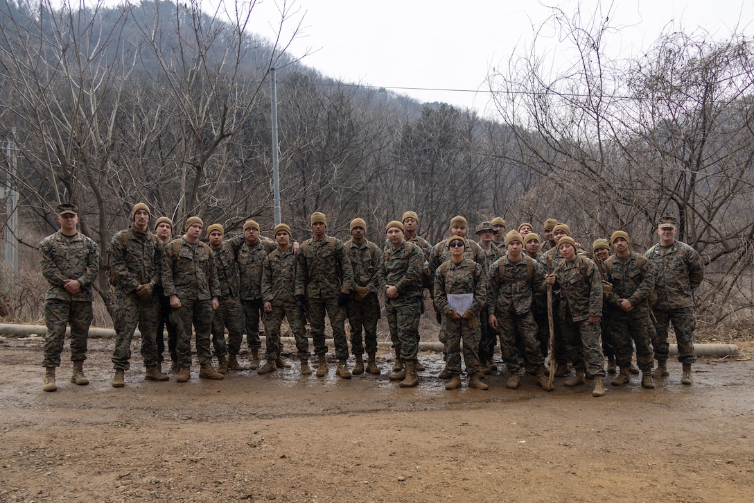 U.S. Marines with Combat Logistics Battalion 4, Combat Logistics Regiment 3, 3rd Marine Logistics Group, pose at the conclusion of land navigation training during the Korean Marine Exchange Program (KMEP) 25.1 at U.S. Army Garrison Casey, South Korea, on March 1, 2025. Land navigation training enables Marines to operate effectively in diverse environments. The KMEP is a semi-annual exercise that provides iterative opportunities for ROK Marine Corps and U.S. Marine Corps units to train together, improving their combined capabilities to deter threats and maintain peace on the Korean Peninsula. (U.S. Marine Corps photo by Cpl. Jonathan Rodriguez Pastrana)