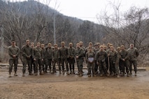 U.S. Marines with Combat Logistics Battalion 4, Combat Logistics Regiment 3, 3rd Marine Logistics Group, pose at the conclusion of land navigation training during the Korean Marine Exchange Program (KMEP) 25.1 at U.S. Army Garrison Casey, South Korea, on March 1, 2025.