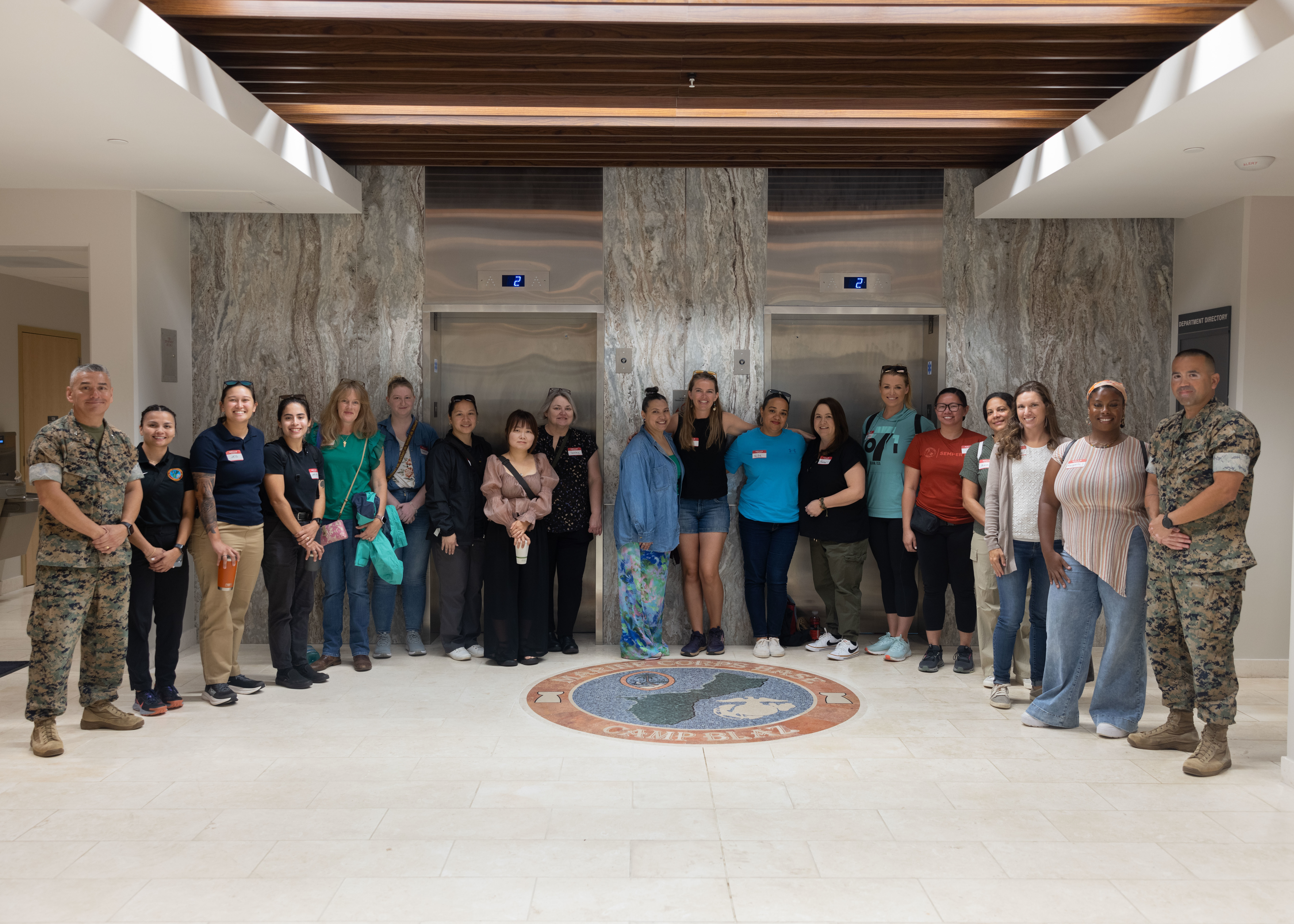 U.S. Marine Corps Col. Ernest Govea, commanding officer, Marine Corps Base Camp Blaz, and Sgt. Maj. Daniel Soto, senior enlisted leader, MCB Camp Blaz, pose with service member spouses stationed at MCB Camp Blaz during a spouse tour at MCB Camp Blaz, March 5, 2025. The spouse tour was held to give military spouses a better understanding of the MCB Camp Blaz build-up and mission. (U.S. Marine Corps photo by Lance Cpl. Tanner Currin)
