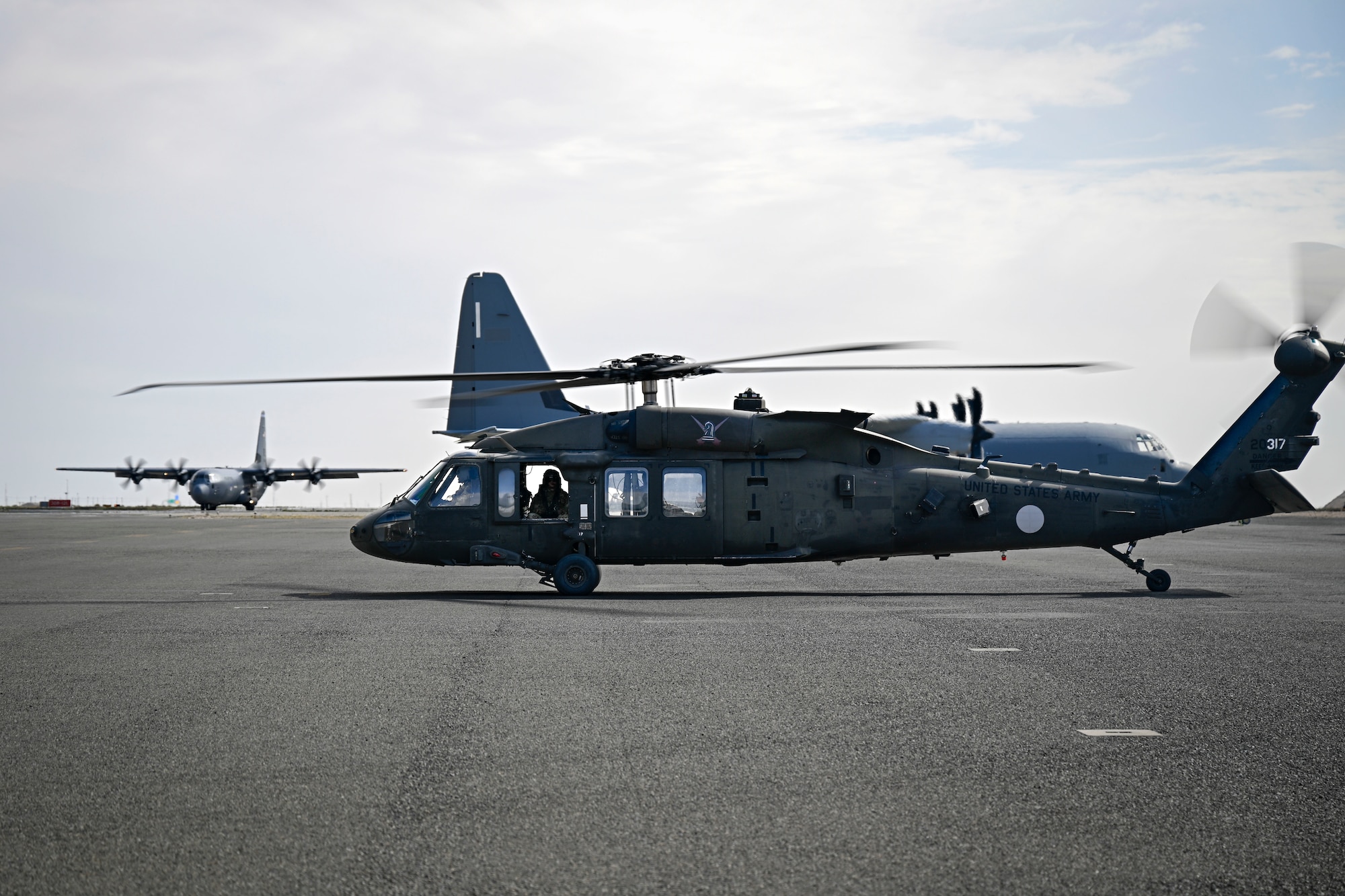 A U.S. Army UH-60 Blackhawk helicopter sits on a flight line.