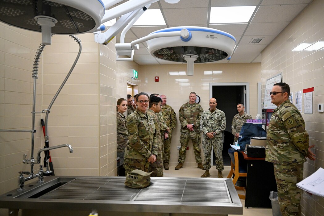 A group of military members talking together inside a veterinary clinic.