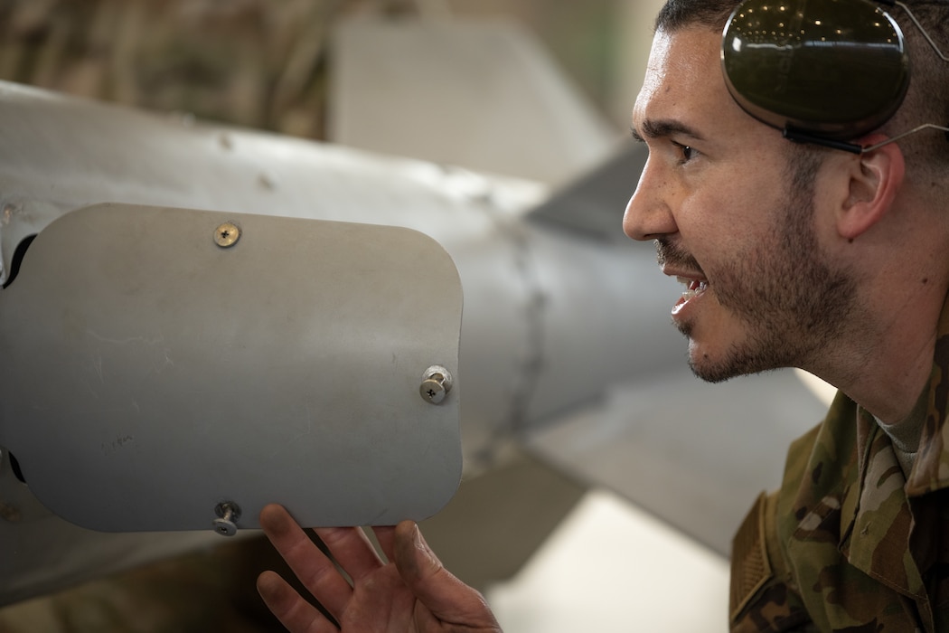 A U.S. Air Force Airman inspects a munition.