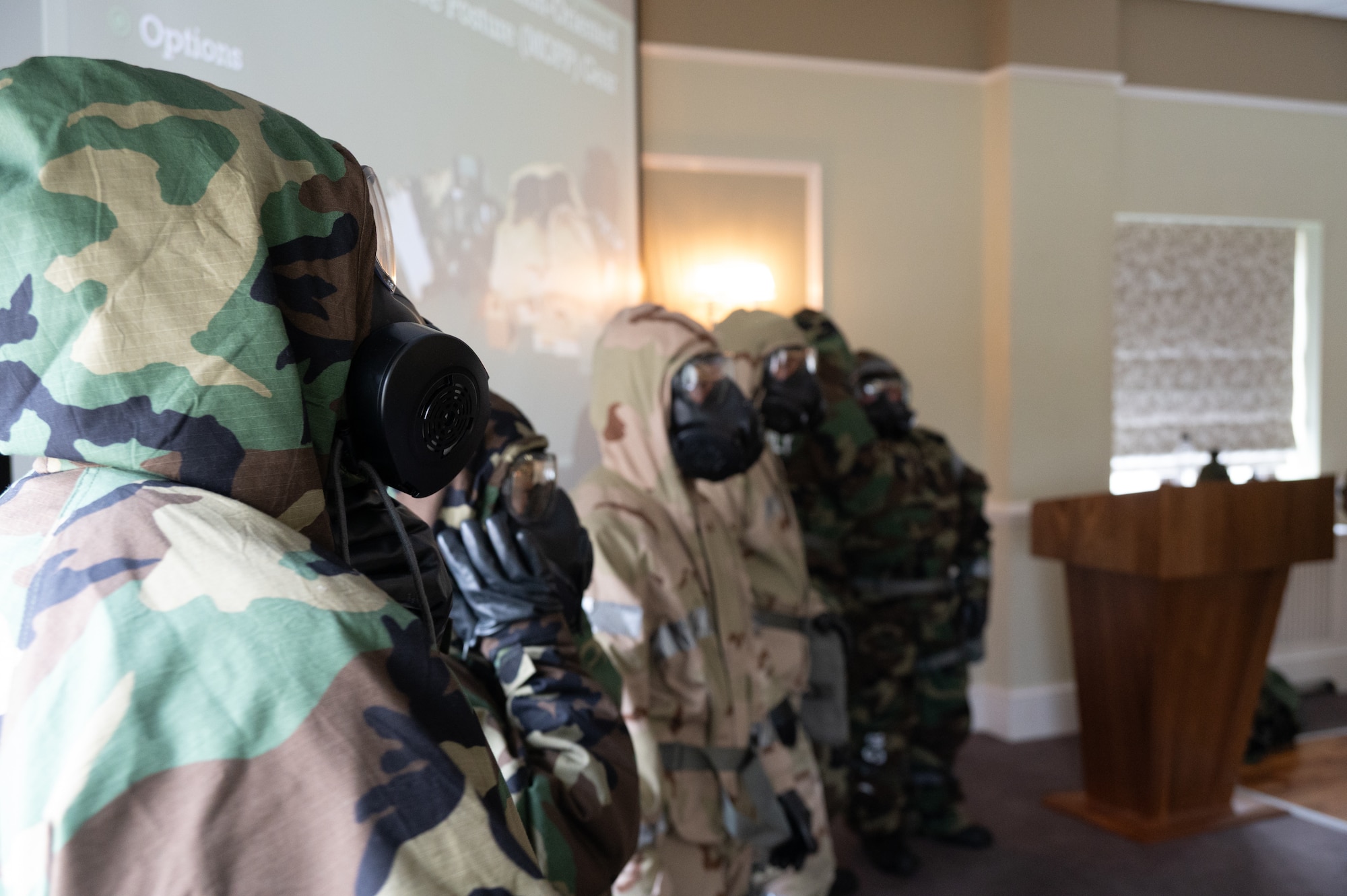 Pathfinders help each other suit up in Mission-Oriented Protective Posture