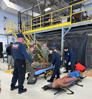 Naval Station Mayport's Helicopter Maritime Strike Squadron (HSM) 50 sailors work with members of First Coast Navy Fire and Emergency Services to learn casualty evacuation training, while staff from Navy Medicine Readiness and Training Command (NMRTC) Jacksonville and Expeditionary Medical Facility-Mike observe and instruct.