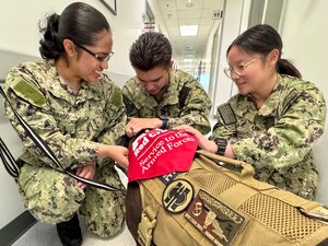 From left, Seaman Recruit Joselyn Alvarado, Seaman Apprentice Jacob Rivera Calvo and Seaman Apprentice Taotao Zhang, were excited to greet Isabel during a visit to U.S. Naval Hospital Guantanamo Bay, Jan. 22, 2025. The Labrador retriever mix is enrolled in the American Red Cross Animal Visitation Program and will become a regular visitor to the hospital beginning Mar. 13, 2025. (U.S. Navy photo by Emily McCamy)