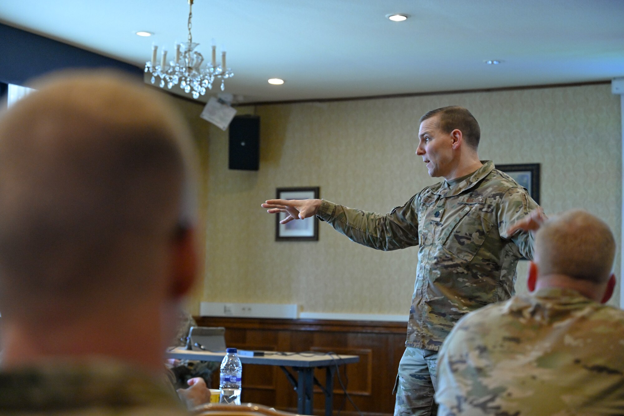 Lt. Col. David Thompson, 521st Air Mobility Operations Wing director of operations, briefs Airmen assigned to the 521 AMOW on Great Power Competition at the Armstrong Club on Vogelweh Military Complex, Germany, Feb. 19, 2025.