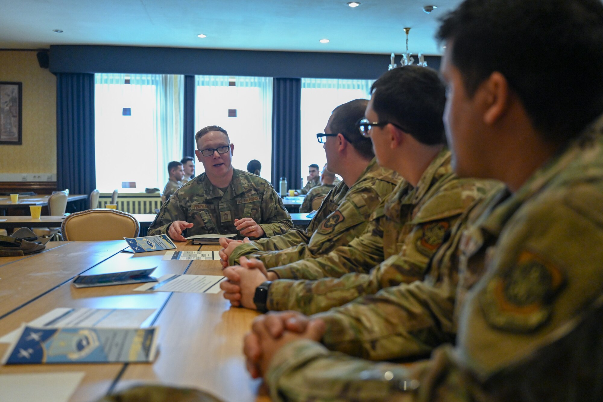 Chief Master Sgt. Joseph Pendland, center, 727th Air Mobility Squadron senior enlisted leader, mentors Airmen assigned to the 521st Air Mobility Operations Wing during a speed mentoring session at the Armstrong Club on Vogelweh Military Complex, Germany, Feb. 19, 2025.