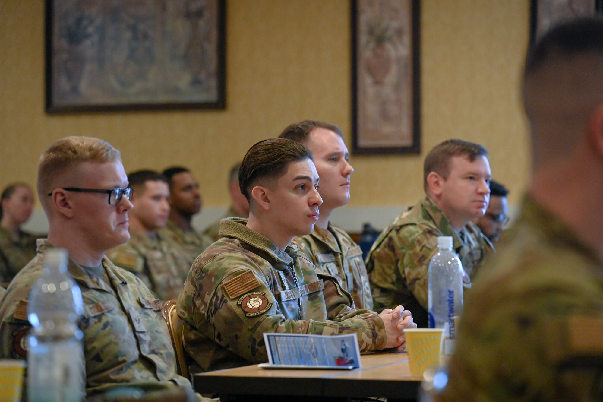 Airmen assigned to the 521st Air Mobility Operations Wing listen to a brief during a professional development seminar at the Armstrong Club on Vogelweh Military Complex, Germany, Feb. 19, 2025.