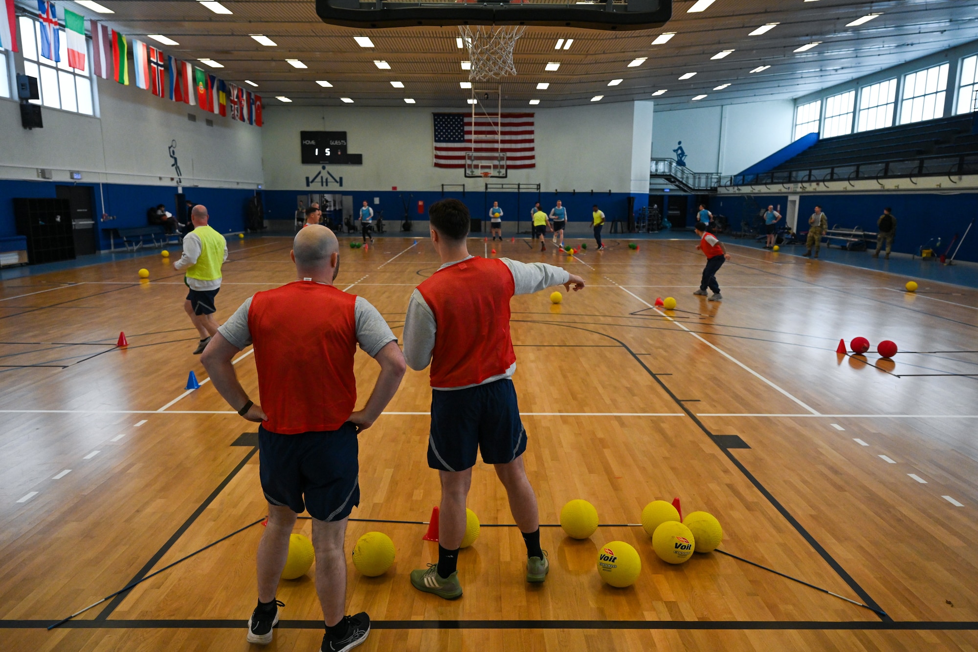 Airmen assigned to the 521st Air Mobility Operations Wing strategize during a game of FLEX Ball at the Vogelweh Fitness Center on Kapaun Air Station, Germany, Feb. 20, 2025.