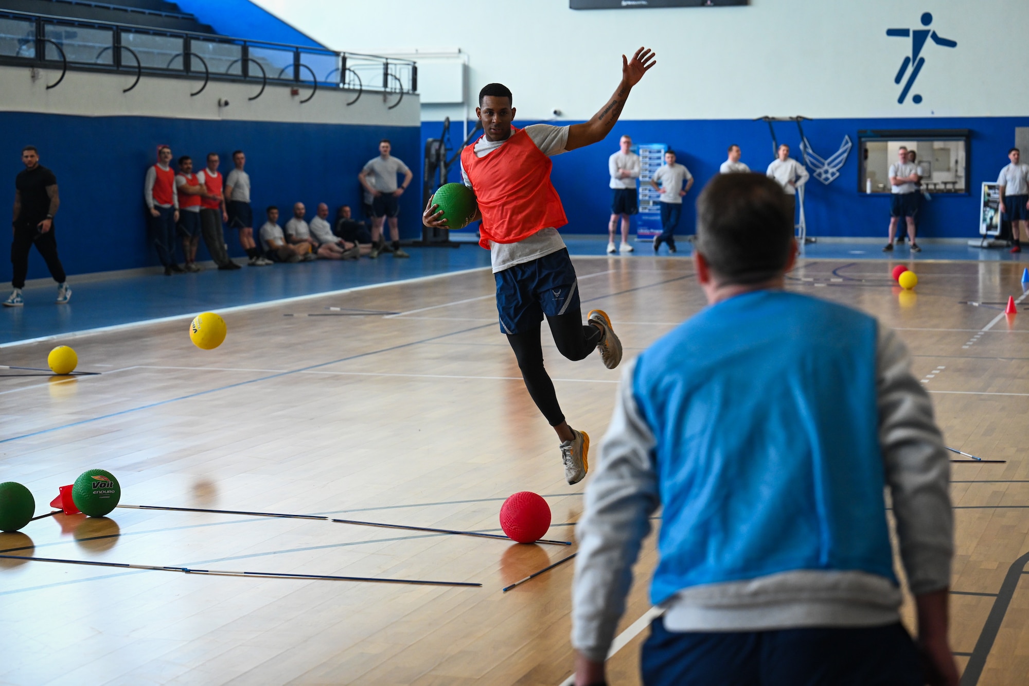 An Airman assigned to the 521st Air Mobility Operations Wing dodges a dodgeball during a game of FLEX Ball at the Vogelweh Fitness Center on Kapaun Air Station, Germany, Feb. 20, 2025.