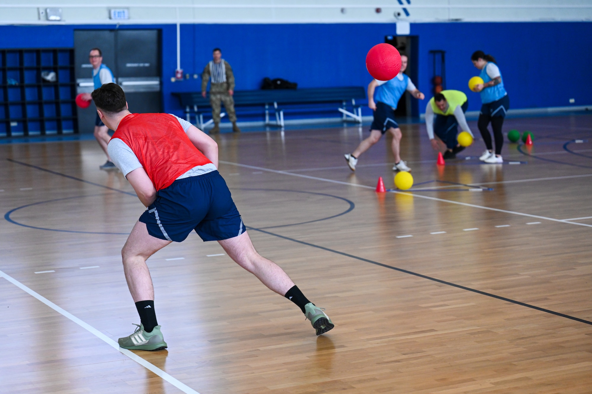 An Airman assigned to the 521st Air Mobility Operations Wing dodges a dodgeball during a game of FLEX Ball at the Vogelweh Fitness Center on Kapaun Air Station, Germany, Feb. 20, 2025.