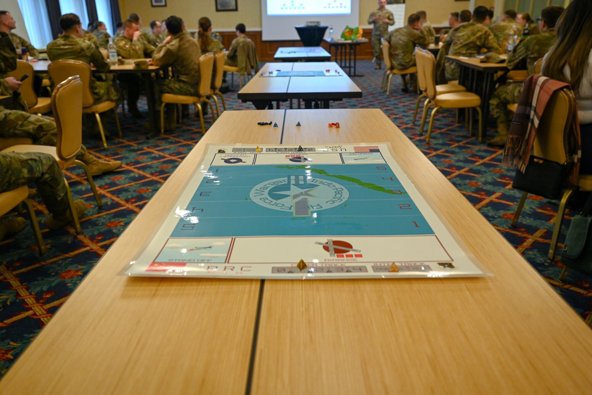 Air Force Wargame Europe and Indo-Pacific Expansion board games are laid out on desks during a professional development seminar at the Armstrong Club on Vogelweh Military Complex, Germany, Feb. 20, 2025.
