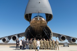 Rep. Sarah McBride of Delaware, center, and her staff members along with Team Dover members stand in front a C-5M Super Galaxy for a photo at Dover Air Force Base, Delaware, March 7, 2025. During her visit, McBride met with 436th and 512th Airlift Wing senior leadership, members of the 436th Aerial Port Squadron, 436th Aircraft Maintenance Squadron, 736th AMXS and stopped by a C-17 Globemaster III for a photo with Team Dover members. (U.S. Air Force photo by Roland Balik)