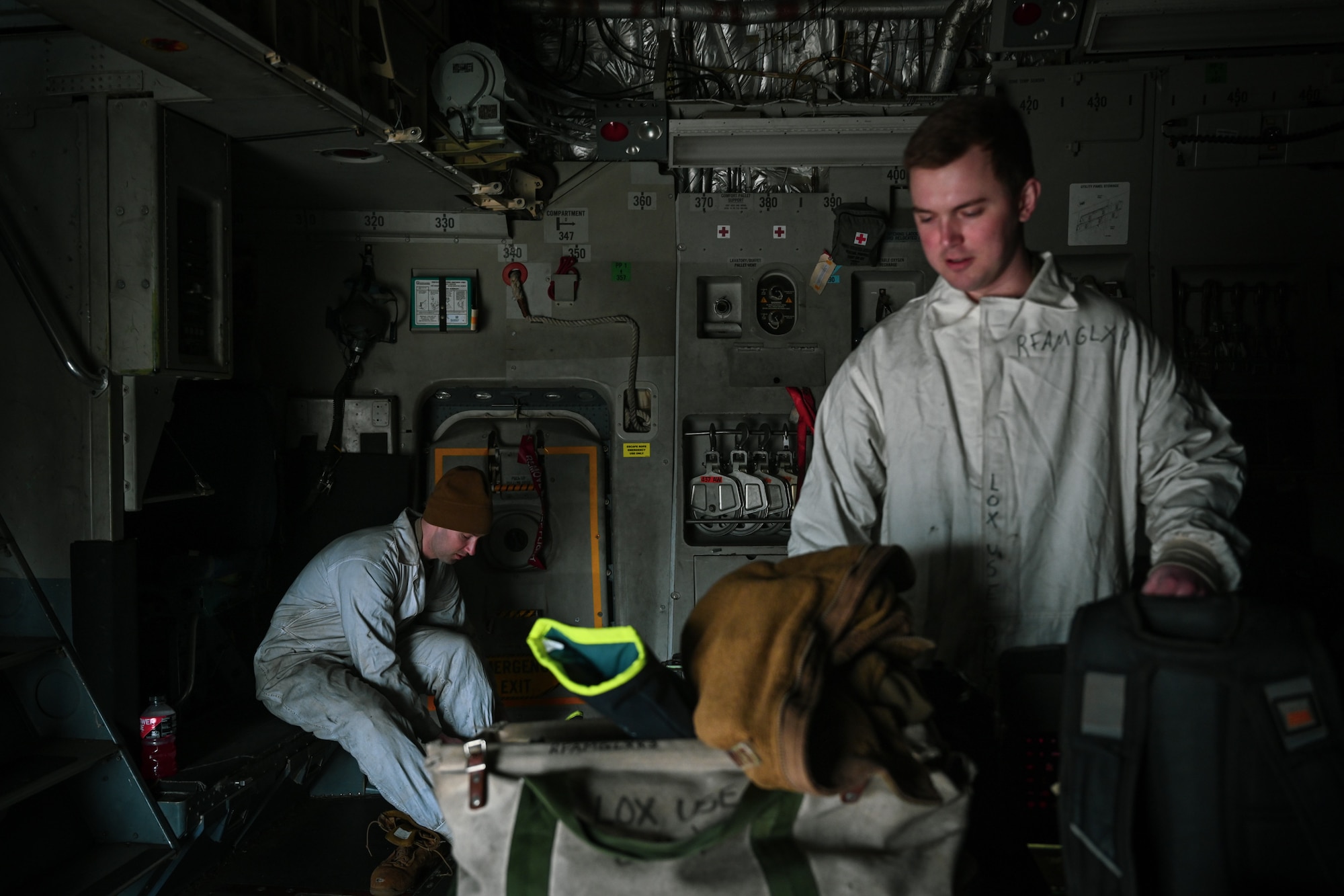 Staff Sgt. James Sullivan, left, a 726th Air Mobility Squadron C-17A Globemaster III crew chief, and Staff Sgt. Terry McGivern, a 726 AMS heavy integrated avionics craftsman, don personal protective equipment prior to carrying out liquid oxygen servicing on a C-17A Globemaster III on Ramstein Air Base, Germany, Feb. 26, 2025.