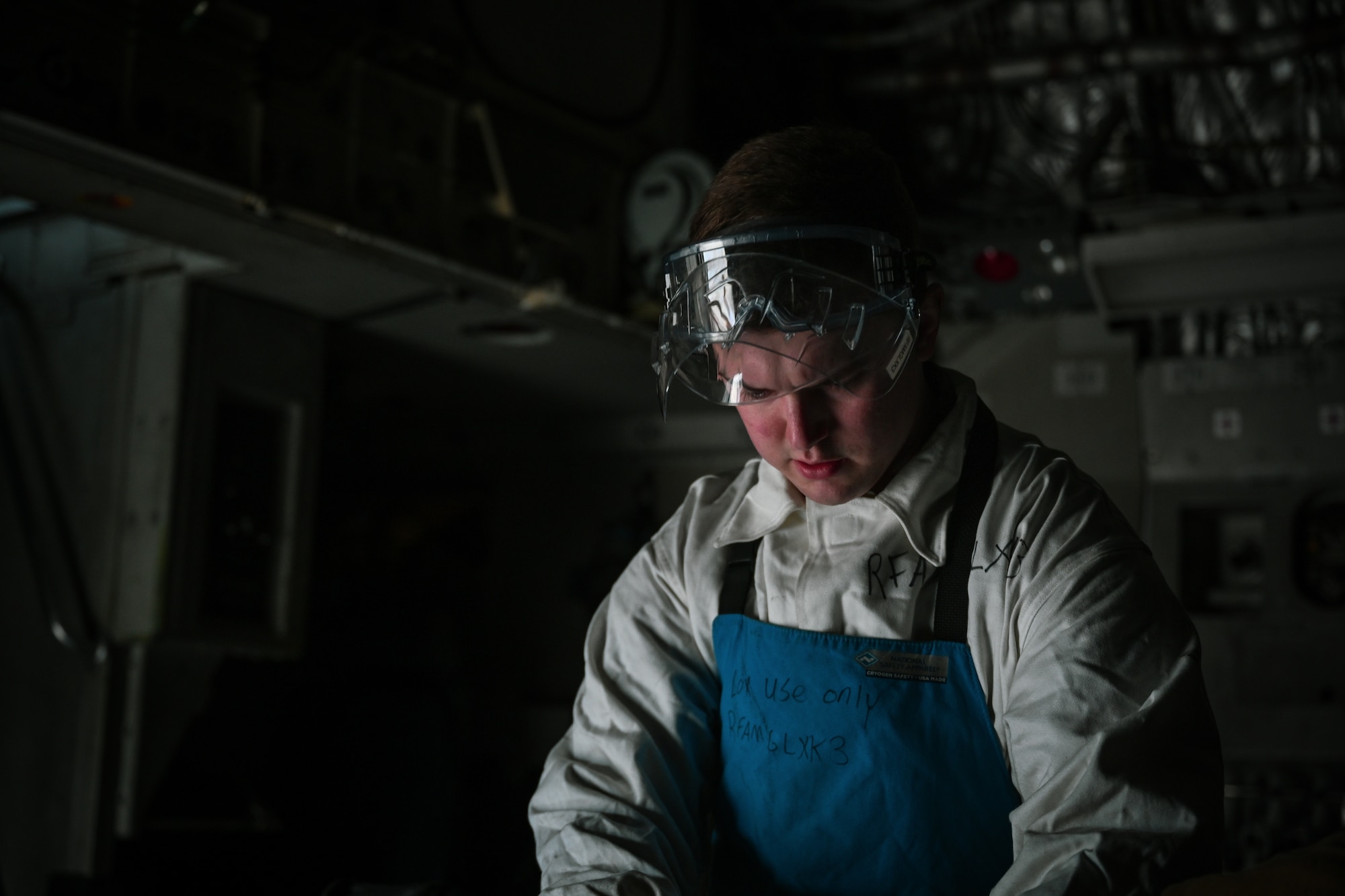 Staff Sgt. Terry McGivern, a 726th Air Mobility Squadron heavy integrated avionics craftsman, don personal protective equipment prior to carrying out liquid oxygen servicing on a C-17A Globemaster III on Ramstein Air Base, Germany, Feb. 26, 2025. (U.S. Air Force photo by Staff Sgt. Joshua T. Crossman)