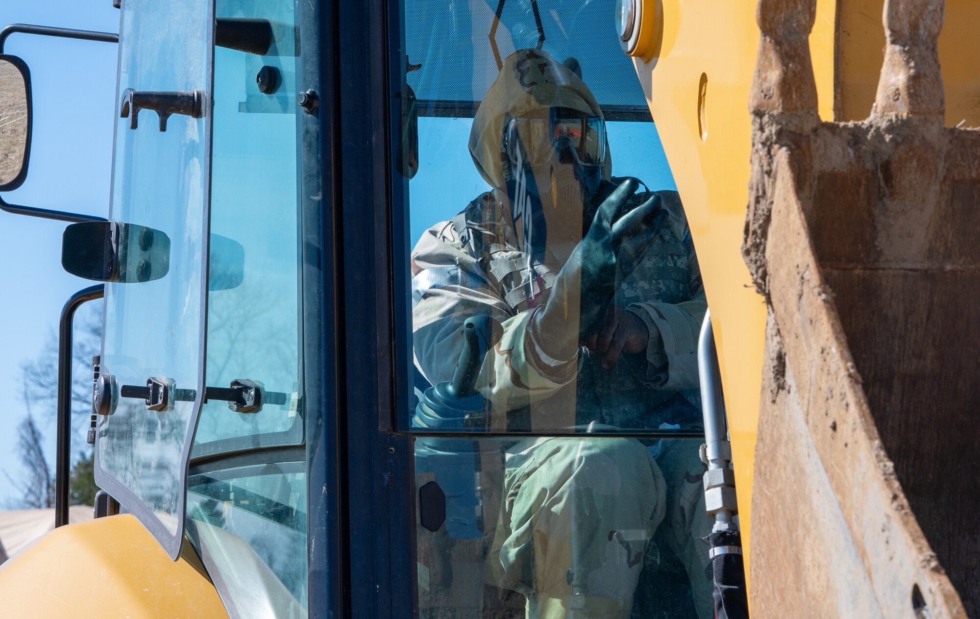 Airmen dons chemical protective gear