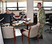 Norfolk Navy Shipyard’s Business and Strategic Planning Officer (Code 1200) Cmdr. Brian Banazwki discusses upcoming projects with Deputy Business and Strategic Planner Officer (Code 1201) George Fitzgerald.
