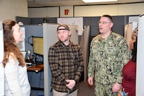 (From Left to Right) Norfolk Naval Shipyard’s Business and Strategic Planning Office (Code 12.51) Workload Forecasting Specialist Sarah Anderson, Workload Forecasting Specialist Christopher Baker, Business and Strategic Planning Officer (Code 1200) Cmdr. Brian Banazwki and Workload Forecasting Specialist Tamara Jones discuss the financial review for the USS Dwight D. Eisenhower (CVN 69).