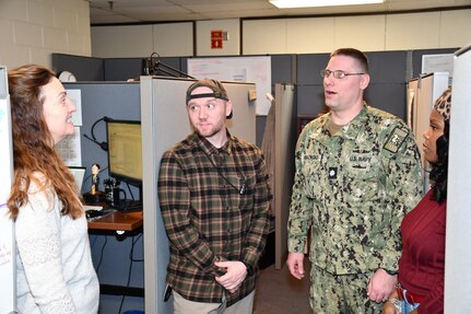 (From Left to Right) Norfolk Naval Shipyard’s Business and Strategic Planning Office (Code 12.51) Workload Forecasting Specialist Sarah Anderson, Workload Forecasting Specialist Christopher Baker, Business and Strategic Planning Officer (Code 1200) Cmdr. Brian Banazwki and Workload Forecasting Specialist Tamara Jones discuss the financial review for the USS Dwight D. Eisenhower (CVN 69).