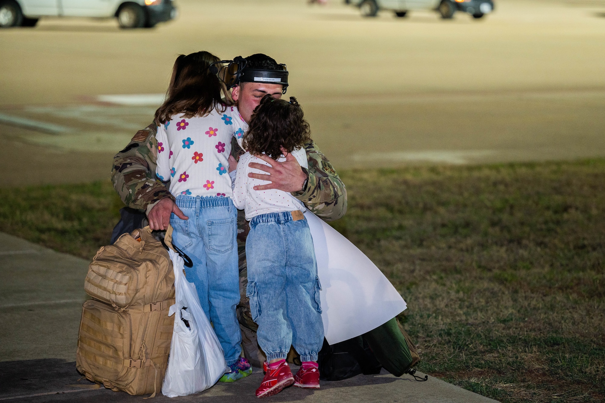 An Airman assigned to the 317th Airlift Wing reunites with his family at Dyess Air Force Base, Texas, March 9, 2025, after a six-month deployment. Airmen and families gathered to welcome members of the 317th Airlift Wing home from supporting taskings in the U.S. Air Forces Central Command area of responsibility. (U.S. Air Force photo by Senior Airman Alondra Cristobal Hernandez)