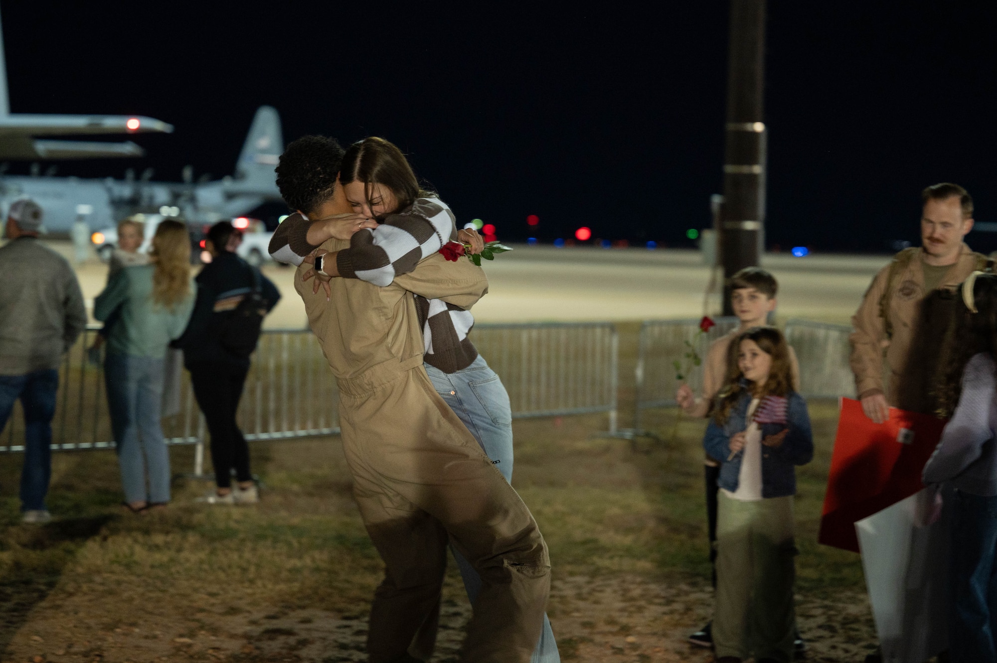 An Airman assigned to the 317th Airlift Wing reunites with his family at Dyess Air Force Base, Texas, March 9, 2025, after a six-month deployment. The 317th Airlift Wing provides combat-capable tactical airland and airdrop operations. (U.S. Air Force photo by Senior Airman Alondra Cristobal Hernandez)