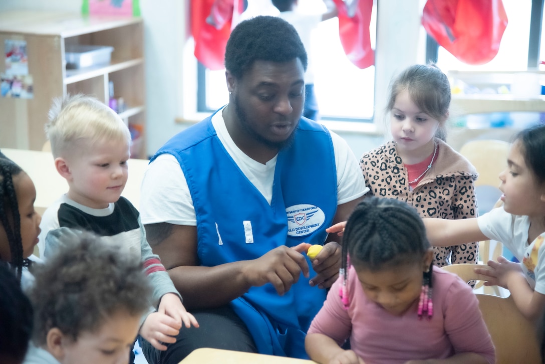 Jaiquez K. Smith, a child and youth program assistant, leads children through a project at the Judith P. Hoyer Child Development Center at Joint Base Andrews, Md., Feb. 25, 2025. Smith has been working at the CDC more than a year and attended the same facility as a child 20 years ago. (U.S. Air Force photo by Patrick Griffith)
