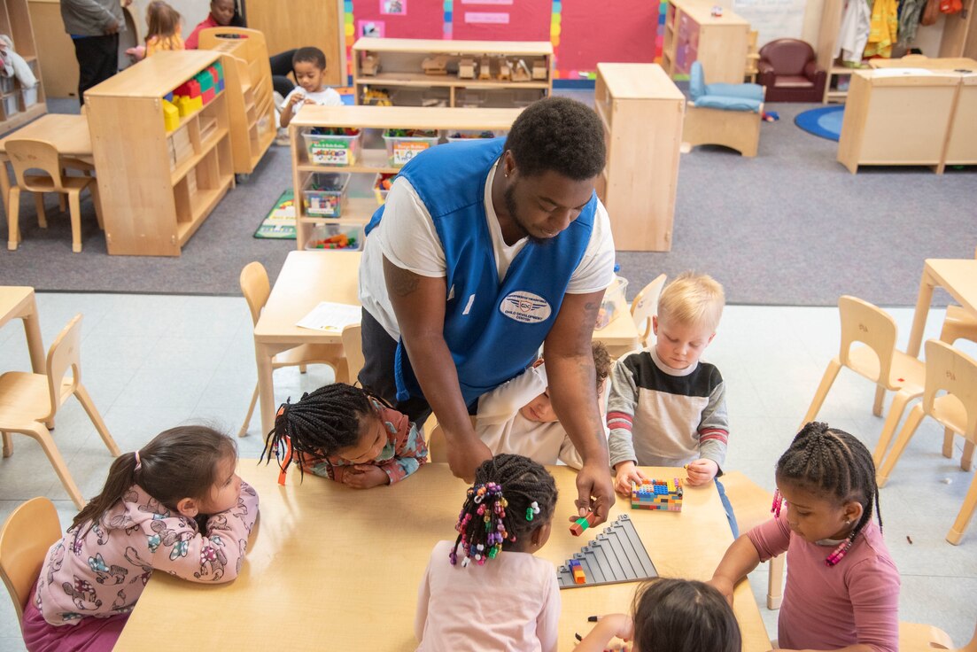 Jaiquez K. Smith, a child and youth program assistant, uses a game to help children learn numbers at the Judith P. Hoyer Child Development Center at Joint Base Andrews, Md., Feb. 25, 2025. As a child, Smith attended the CDC and took a position on the staff 20 years later. (U.S. Air Force photo by Patrick Griffith)