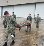 Personnel from Helicopter Maritime Strike Squadron (HSM) 50 stationed at Naval Station (NS) Mayport practice loading patients for rapid transport while Lt. j.g. Brooke Boord of Expeditionary Medical Facility-Mike observed and instructed with other staff from Navy Medicine Readiness and Training Command (NMRTC) Jacksonville.