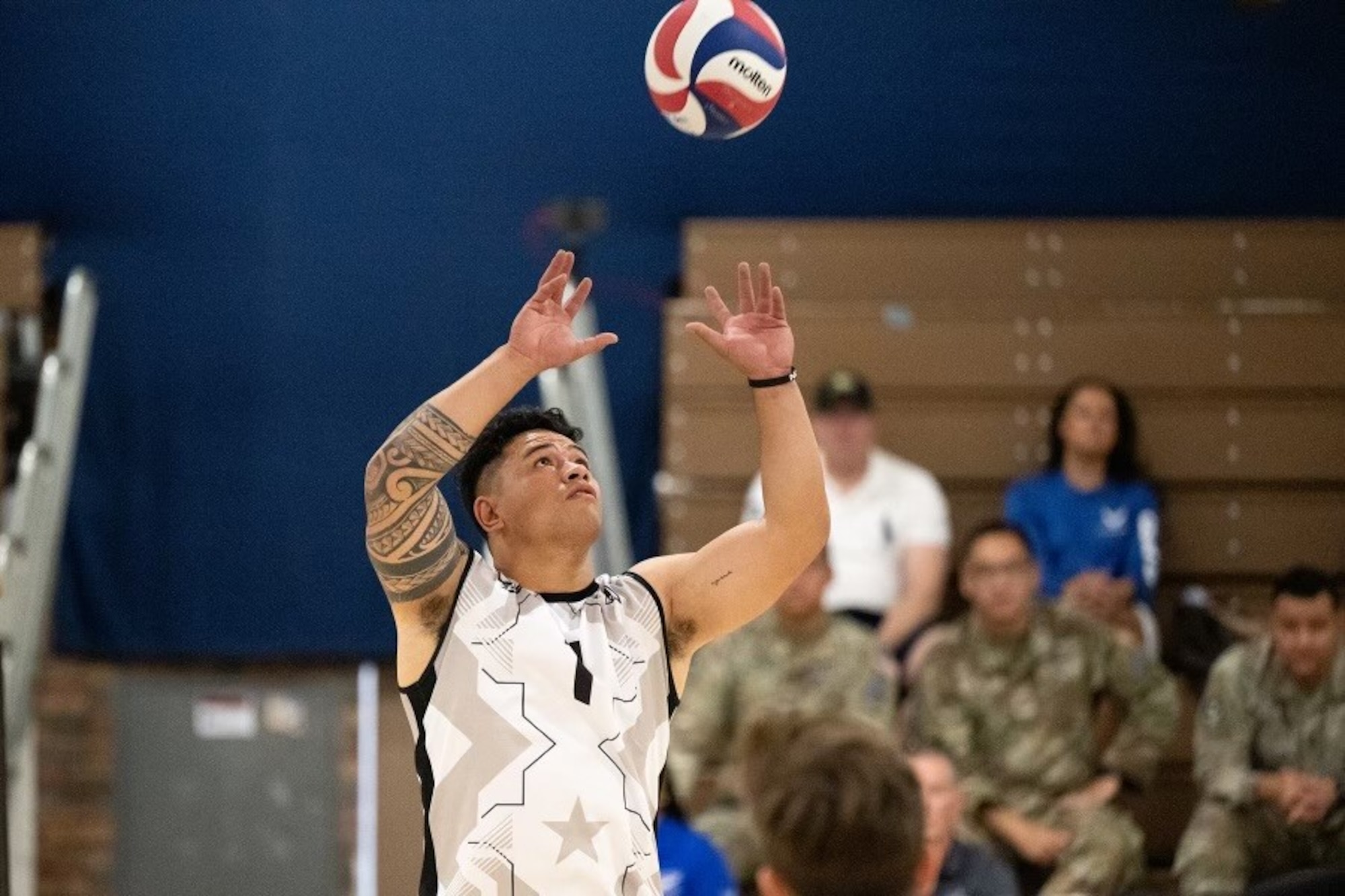 a volleyball player looks to make contact with the ball