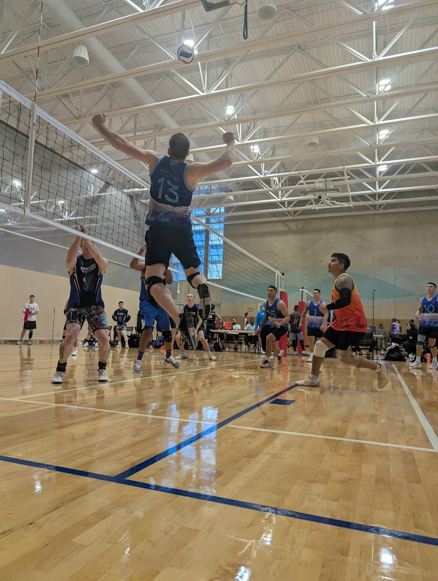 A volleyball player jumps to hit the ball