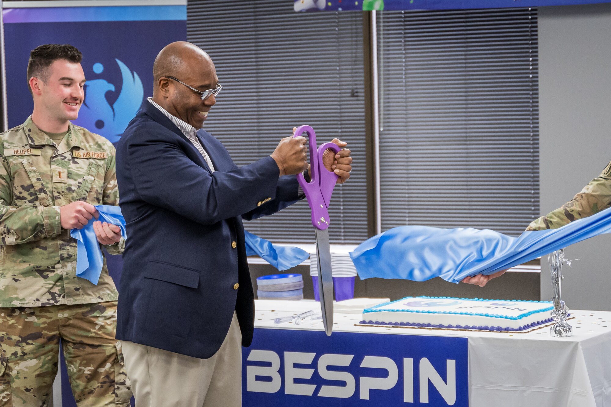 BES Program Executive Officer, Alvin Burse performing the ceremonial ribbon cutting.