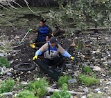 Warm weather brings out huge crowd for annual Basura Bash creek cleanup