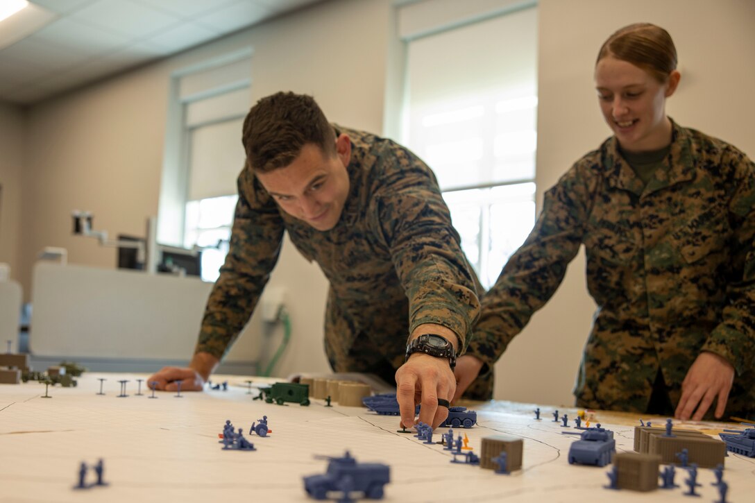 U.S. Marine Corps Capt. Jonathan Coronel, a media operations and assessments officer with II Marine Expeditionary Force (II MEF), moves a simulated drone game piece during the wargame “Down Range” at Marine Corps Base Camp Lejeune, North Carolina, March 6, 2025. Down Range is a flexible, quick-to-learn wargame that lets players explore scenarios with over 100 individual units in a fast-paced environment, created by Capt. Nicholas Royer, a modeling and simulation officer with II MEF. (U.S. Marine Corps photo by Cpl. Marc Imprevert)