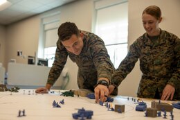 U.S. Marine Corps Capt. Jonathan Coronel, a media operations and assessments officer with II Marine Expeditionary Force (II MEF), moves a simulated drone game piece during the wargame “Down Range” at Marine Corps Base Camp Lejeune, North Carolina, March 6, 2025. Down Range is a flexible, quick-to-learn wargame that lets players explore scenarios with over 100 individual units in a fast-paced environment, created by Capt. Nicholas Royer, a modeling and simulation officer with II MEF. (U.S. Marine Corps photo by Cpl. Marc Imprevert)