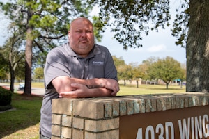 Man standing by sign