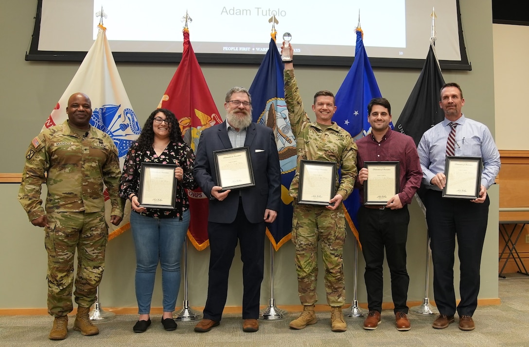 Defense Logistics Agency Troop Support's Commander Army Brig. Gen. Landis Maddox, poses with the Construction and Equipment supply chain's Class IV, or construction and barrier material, Activity Requirements Integration Taxonomy generator team during an awards ceremony March 11. The group, received the DLA Troop Support 2024 innovation team  award. Logistics program specialist Gary “Rick” Lake received the award for an individual.