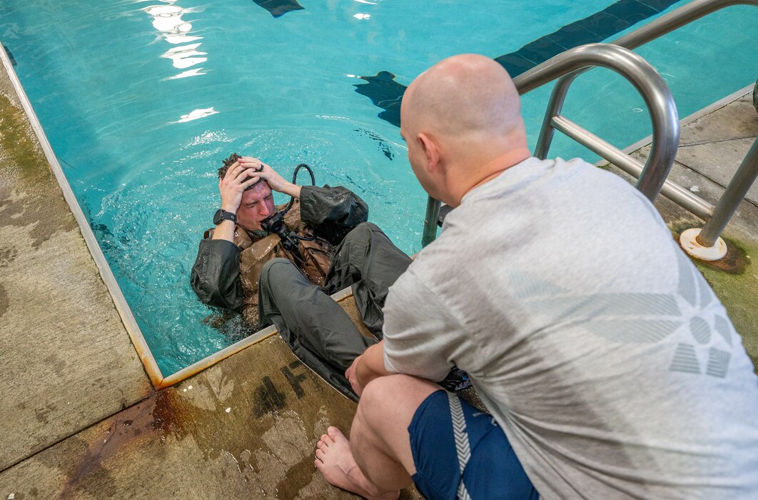 a man exits a pool