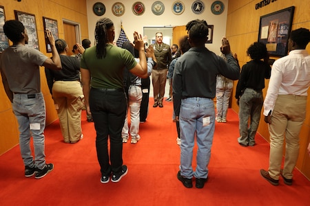 U.S. Army Cyber Center of Excellence Commanding General Maj. Gen. Ryan Janovic administers the Oath of Enlistment to 14 future Servicemembers at the Atlanta Military Entrance Processing Station at Gillem Enclave March 11, 2025.