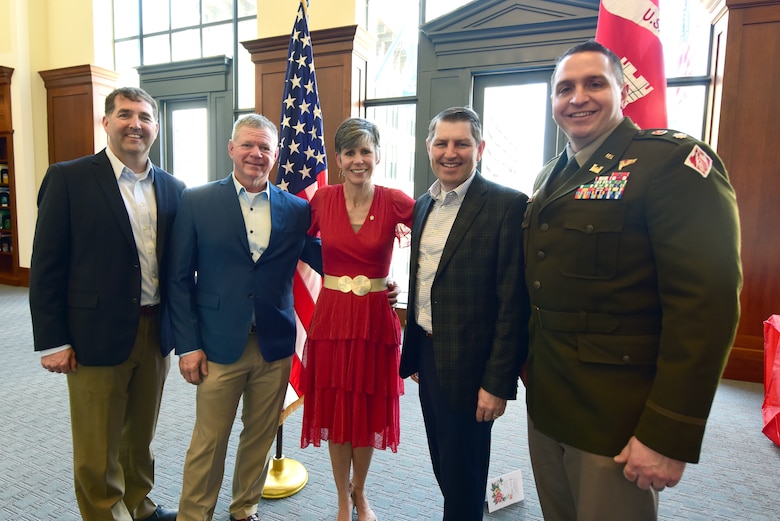 Joanne Mann, U.S. Army Corps of Engineers Nashville District executive officer and congressional liaison, poses with her husband David (Second from Left); Lt. Col. Robert Green (Far Right), Nashville District commander; and former Nashville District Commanders Col. Stephen Murphy (Far Left) and Retired Col. John Hudson at the conclusion of her retirement ceremony March 12, 2025, in the Nashville Public Library in Nashville, Tennessee. She faithfully served 16 consecutive commanders in the Nashville District during a 38-year career in federal service. (USACE Photo by Lee Roberts)