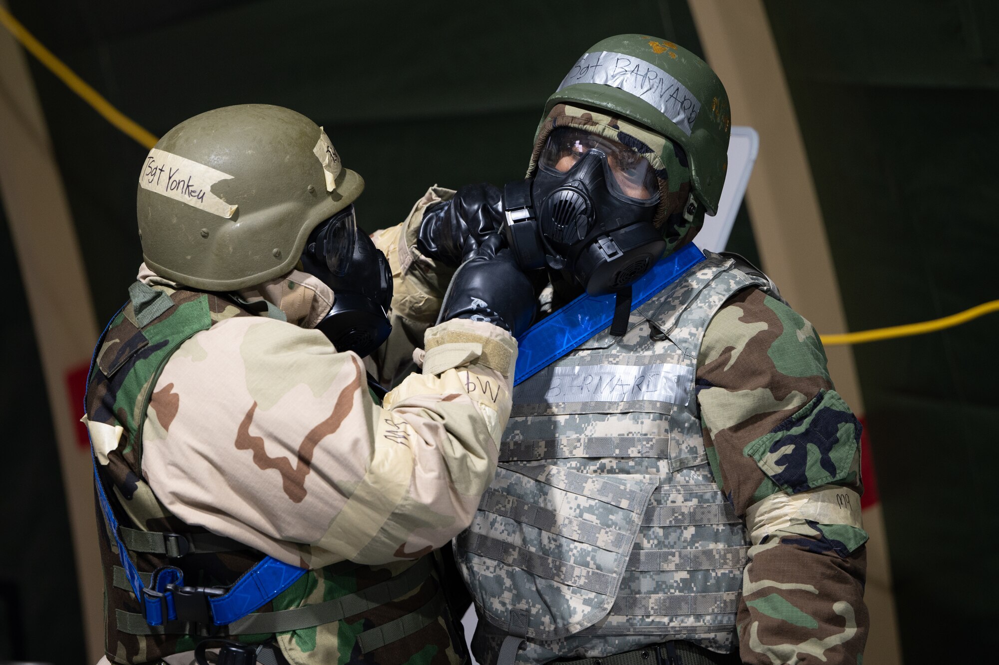 Airmen adjusts gas mask