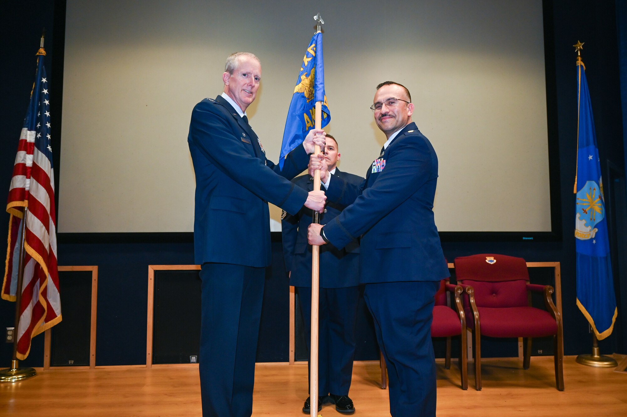 Col. Thomas F. Albrecht, 433rd Maintenance Group commander, presents the 433rd Aircraft Maintenance Squadron guidon to Maj. Carlos A. Rocha, 433rd AMXS commander, during an assumption of command ceremony at Joint Base San Antonio-Lackland, Texas, March 1, 2025.