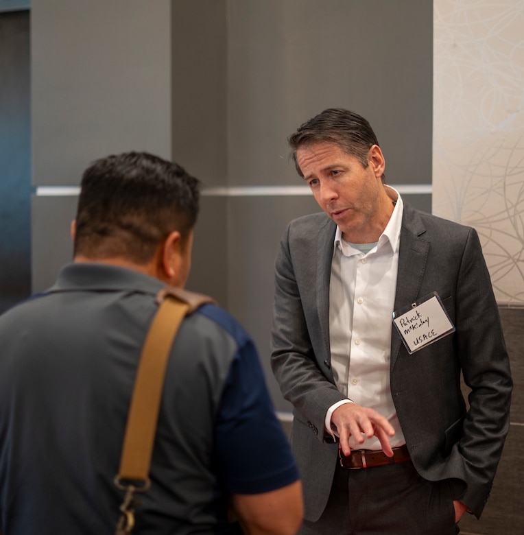 Patrick McKinley, U.S. Army Corps of Engineers Los Angeles District Mega Projects Division chief, right, talks with an attendee of the 2025 Business Opportunities Open House, which the LA District hosted March 6 in Montebello, California.