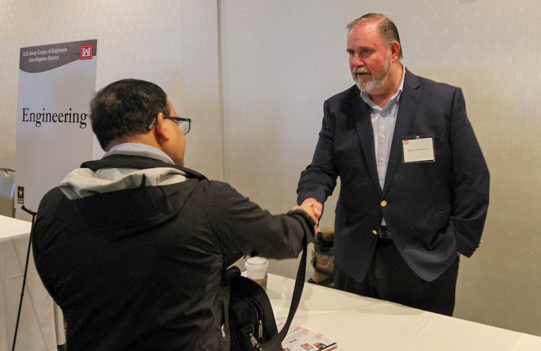 Paul Underwood, U.S. Army Corps of Engineers Los Angeles District Engineering Division chief, right, talks with an attendee of the 2025 Business Opportunities Open House, which the LA District hosted March 6 in Montebello, California.