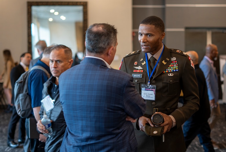 Lt. Col. Stephen Brooks, U.S. Army Corps of Engineers Los Angeles District deputy commander, right of center, speaks with an attendee of the 2025 Business Opportunities Open House, which the LA District hosted March 6 in Montebello, California.