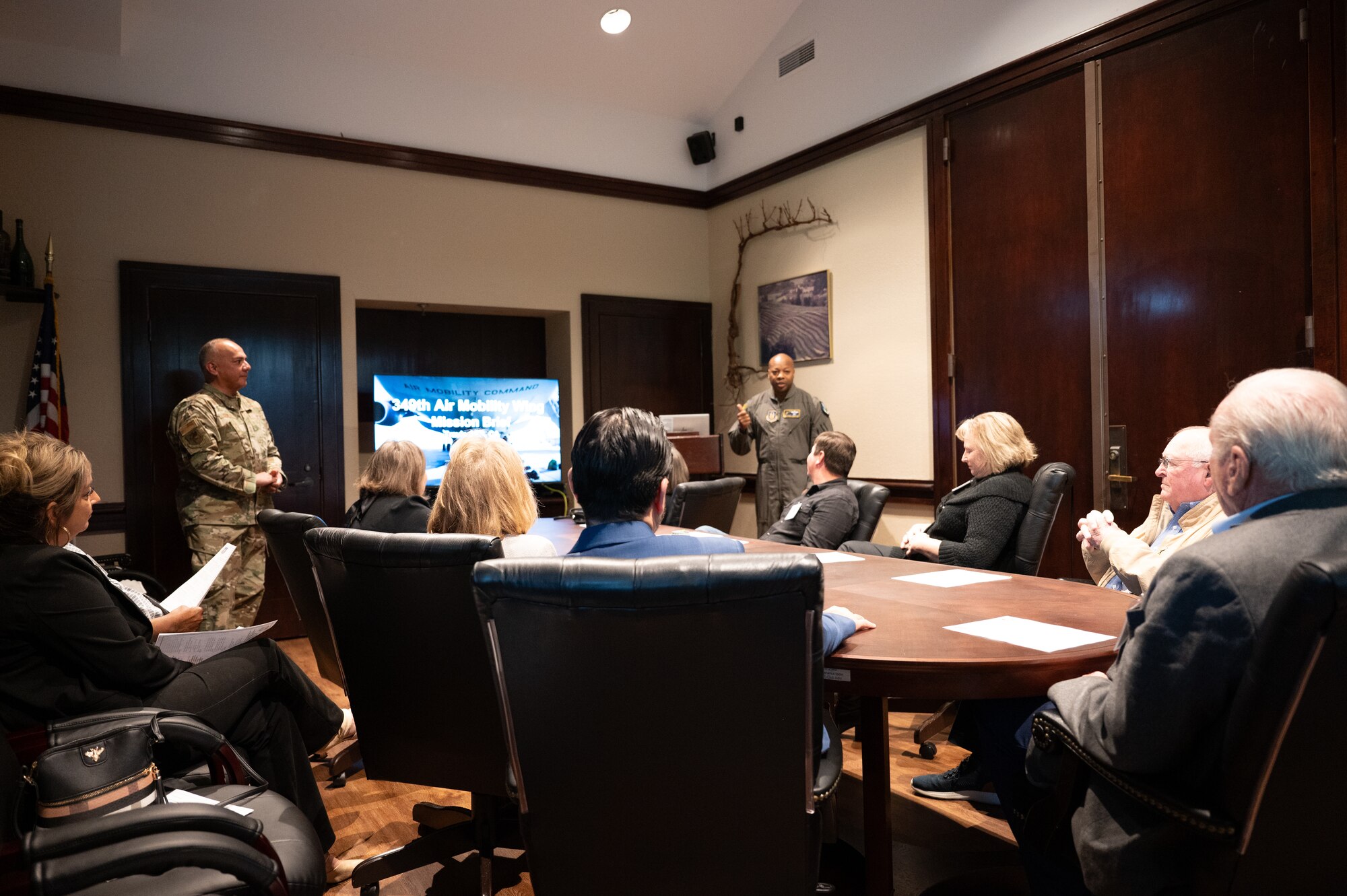 Col. Brady-Lee speaks with members while they sit at a conference table.