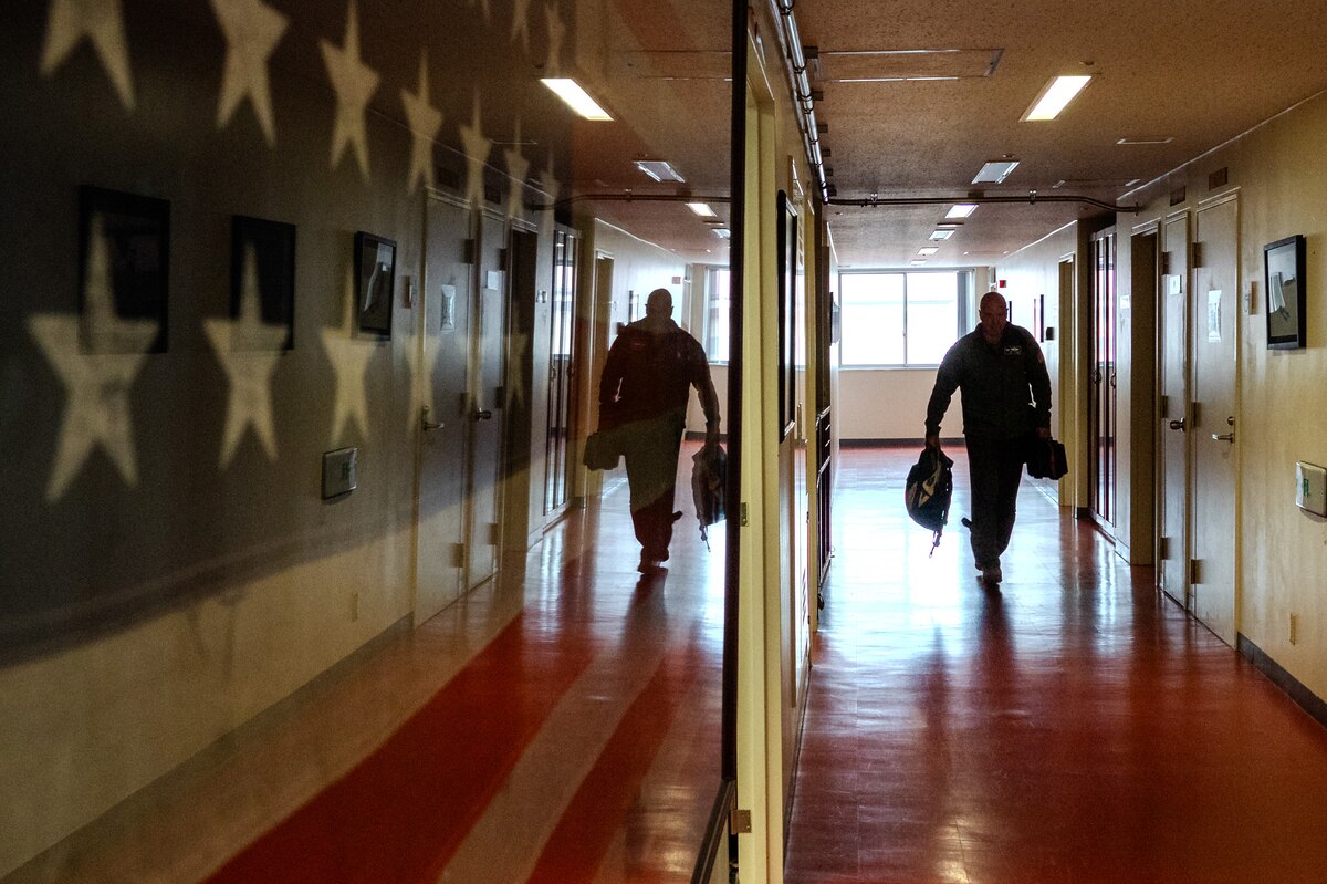 An individual walking down a hallway
