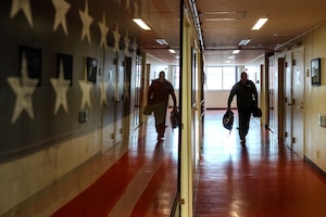 An individual walking down a hallway