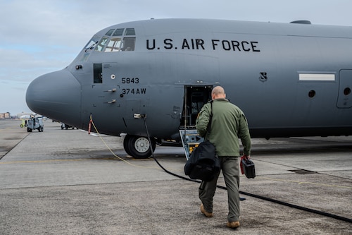 An Airman walking up to a C-130J aircraft